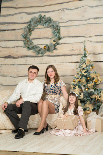 Family new year's eve around the Christmas tree - Fotografie, Obrázek