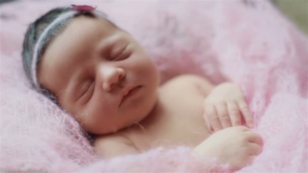 Extra close up macro of adorable little newborn baby girl sleeping covered with a light pink knitted blanket - Footage, Video