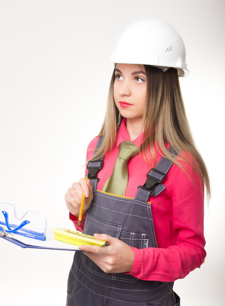 beautiful woman civil engineer holding blueprints. young female architect - Фото, зображення