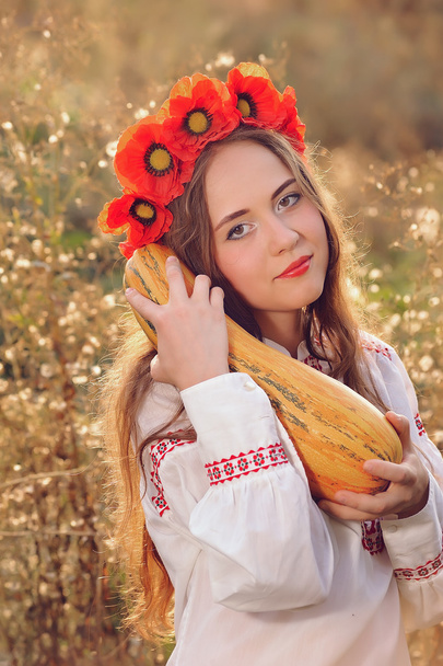 Girl in the Ukrainian national native costume with zucchini - Photo, Image
