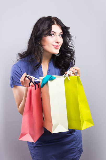 Beautiful brunette with Shopping bags.Portrait of a young woman with new purchases - Fotografie, Obrázek