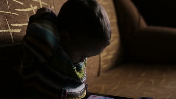 Little boy in hood browse tablet pc - Filmati, video