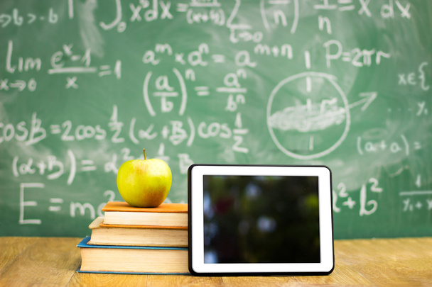 Digital tablet and apple on stack of books - Фото, зображення