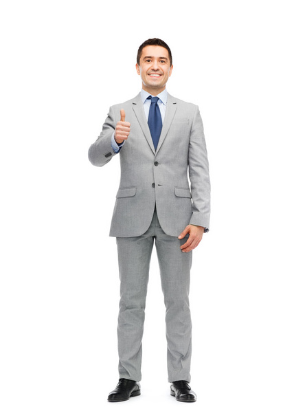happy businessman in suit showing thumbs up - Foto, Imagen