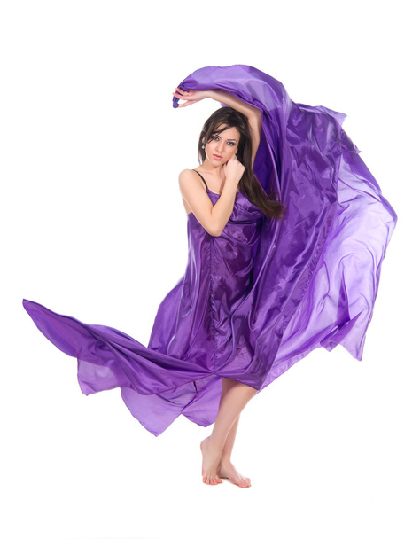 Graceful girl in flying purple silk dress - Фото, зображення