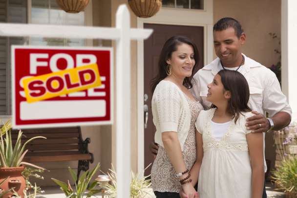 Hispanic Family in Front of Home with Sold Real Estate Sign - Foto, Imagem