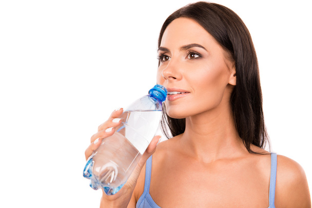 Slim cute girl holding a bottle with water - Foto, imagen