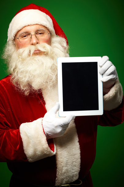 Santa Claus with touchpad - 写真・画像
