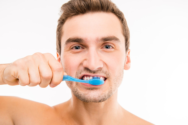 Close up photo of attractive man brushing his teeth - Photo, image