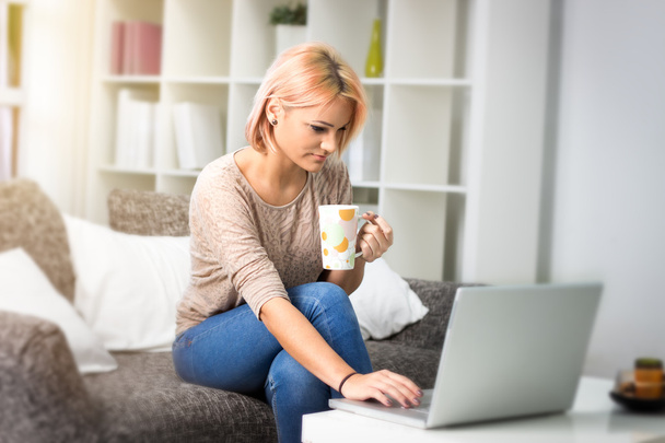 young woman resting with a laptop and coffee - Foto, immagini