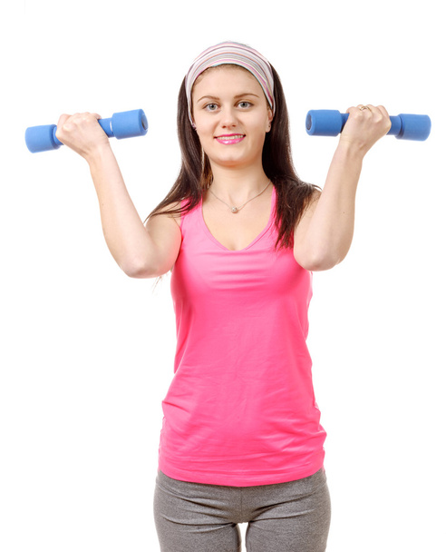 Pretty teenager with weights isolated on a white background  - Valokuva, kuva