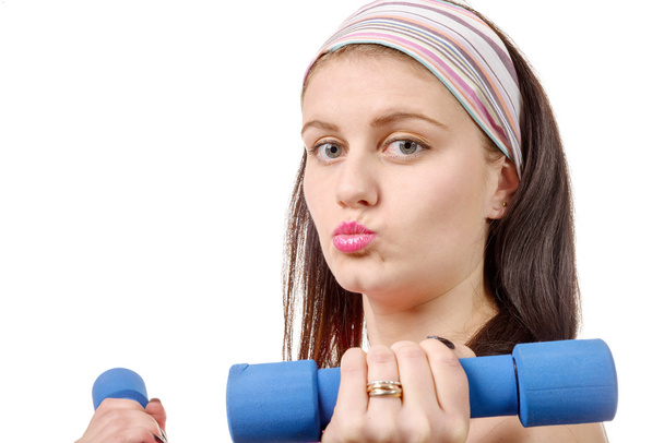 portrait of pretty sporty girl holding weights isolated on white - Foto, afbeelding
