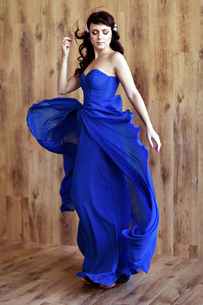Very cute sensual beautiful girl brunette in blue flowing dress - Photo, image