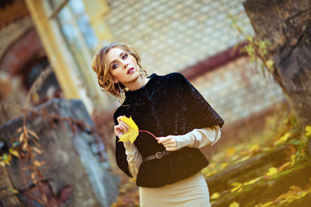 Portrait of a sensual kinky girl in the black coat with the shee - Fotografie, Obrázek