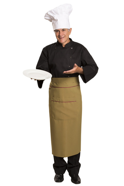 Confident mature chef in black uniform holding empty plate. - Zdjęcie, obraz