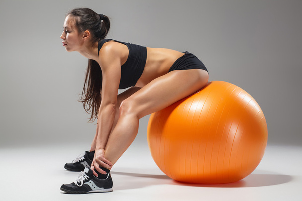 The young, beautiful, sports girl doing exercises on a fitball - Foto, Imagem