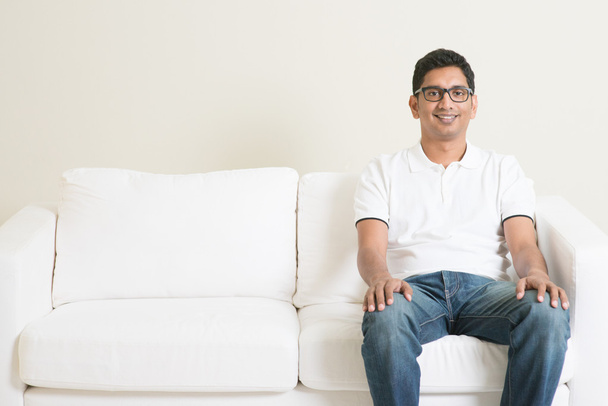 Lonely single Asian man sitting on couch  - Valokuva, kuva