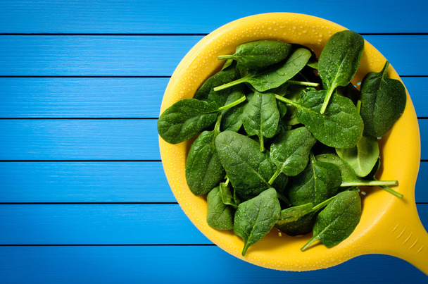 Fresh spinach in yellow colander - Photo, image