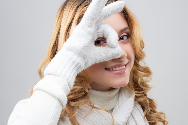 close-up portrait of a blonde girl in a warm white pullover isolated on white background - Valokuva, kuva
