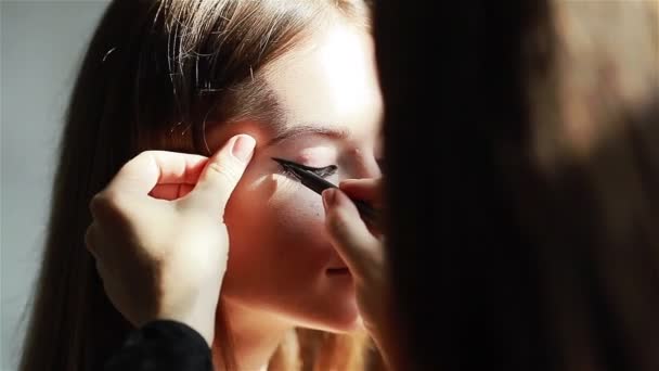 Profesjonalny makijaż artysty stosowania skrzydlaty eyeliner. Szczelnie-do góry - Materiał filmowy, wideo