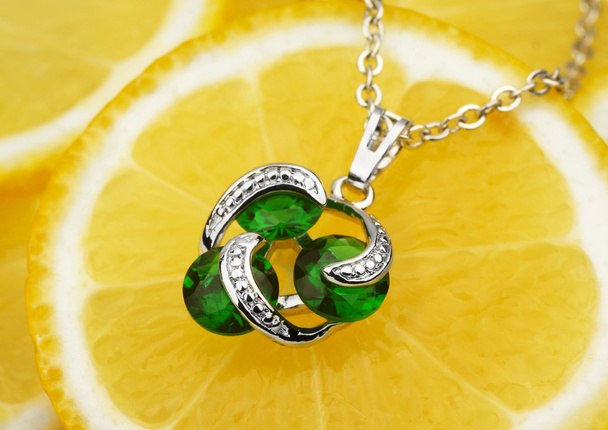 colourful jewellery pendant with gems and diamonds on lemon back - Foto, Bild