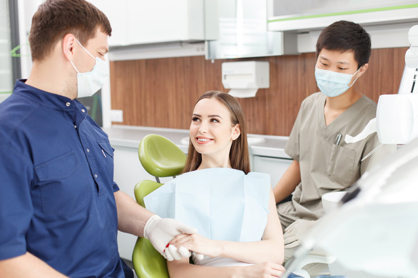 Pretty young woman is visiting her dentist - 写真・画像