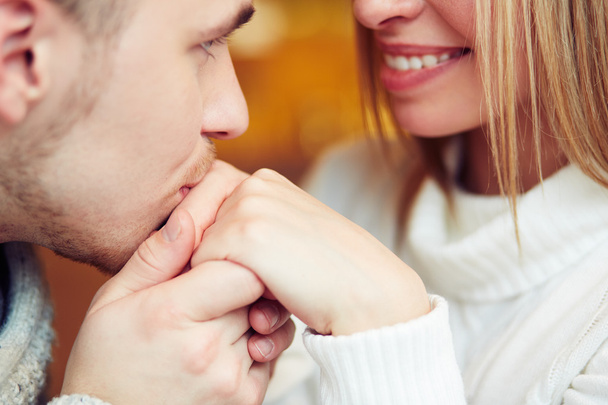 Guy kissing hand of his girlfriend - Foto, afbeelding