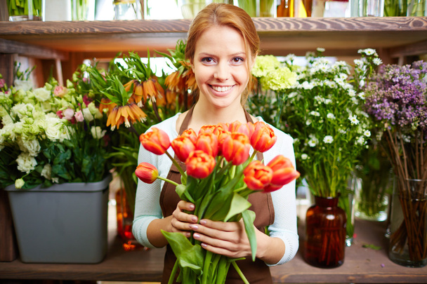 Happy woman with fresh red tulips - Photo, Image