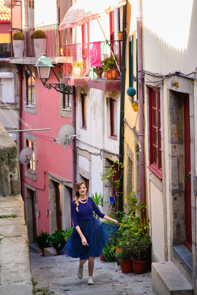 young girl stands on the street among in Porto  - Foto, afbeelding