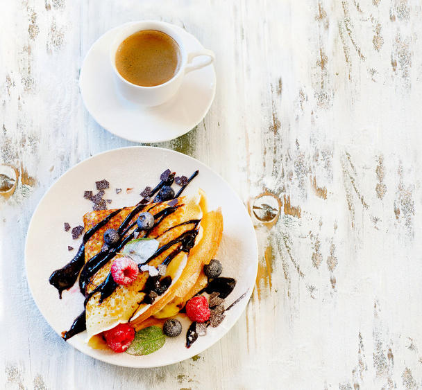Cup of Coffee and Crepes with fresh berries. - Фото, изображение