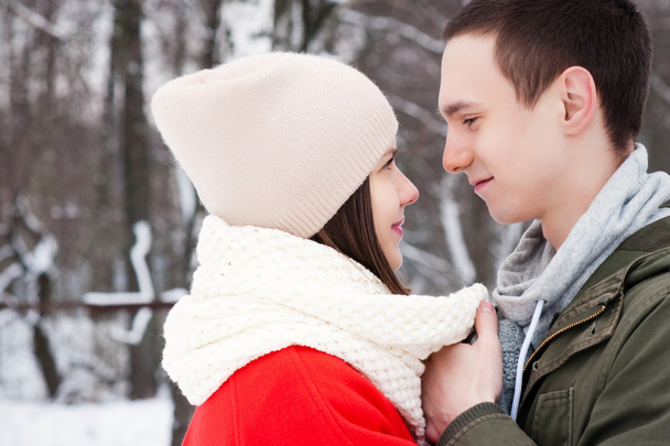 Happy Young Couple in Winter Park having fun.Family Outdoors. love kiss - Φωτογραφία, εικόνα