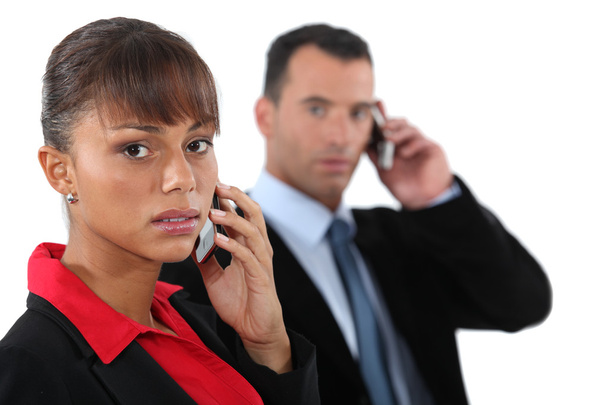 Two business colleagues stood making calls - Фото, изображение