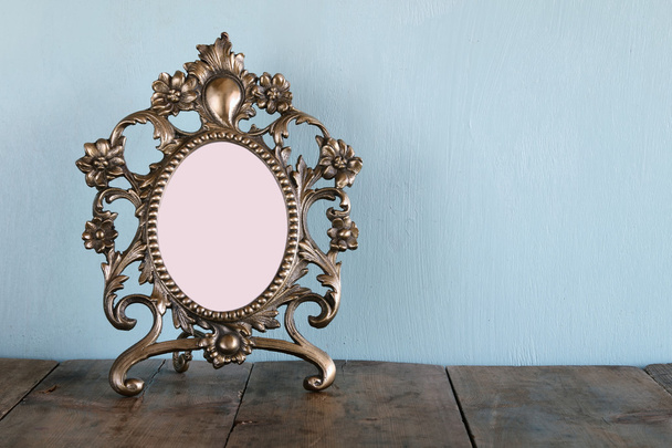 Antique blank victorian style frame on wooden table. retro filtered image. template, ready to put photography - Photo, Image