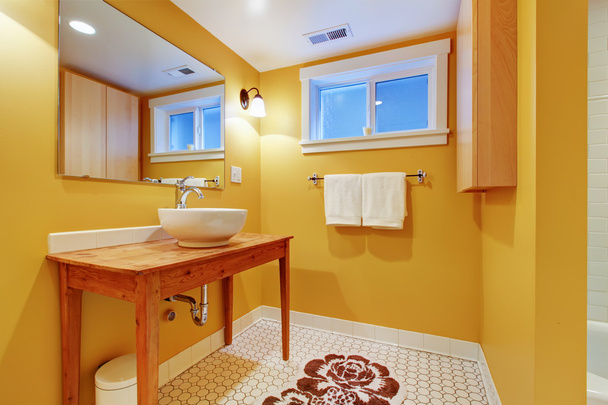 Orange modern bathroom with round sink. - Fotografie, Obrázek
