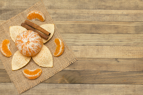 két bottal fahéj és mandarin gyümölcs fa háttér - Fotó, kép