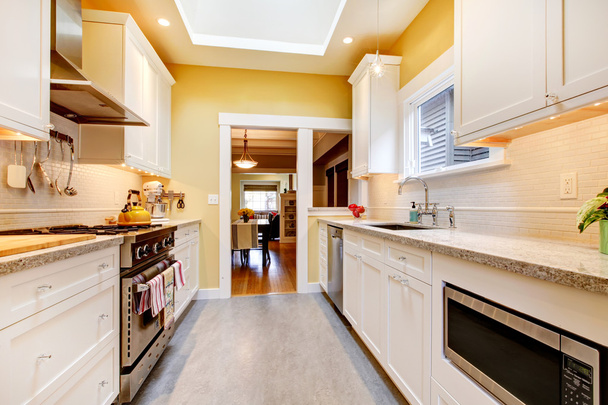 Yellow and white simple kitchen with skylight. - Foto, Imagen
