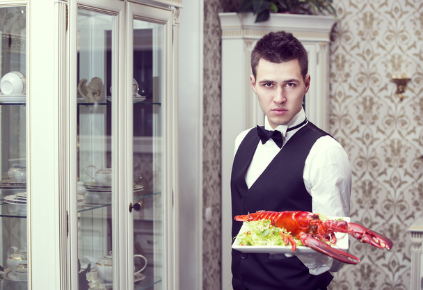 waiter with a tray of food - Фото, изображение