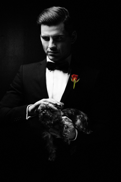 Portrait of man with dog, godfather-like character. - Photo, Image