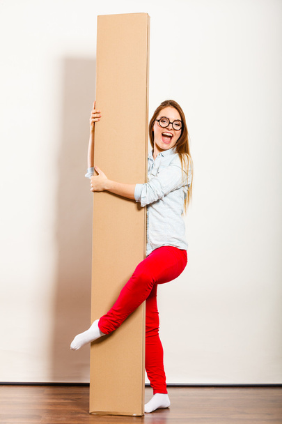 Funny woman  holding box. - Foto, afbeelding