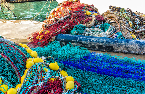 Pile of Fishing Nets with Floats and Colorful Ropes Stock Image