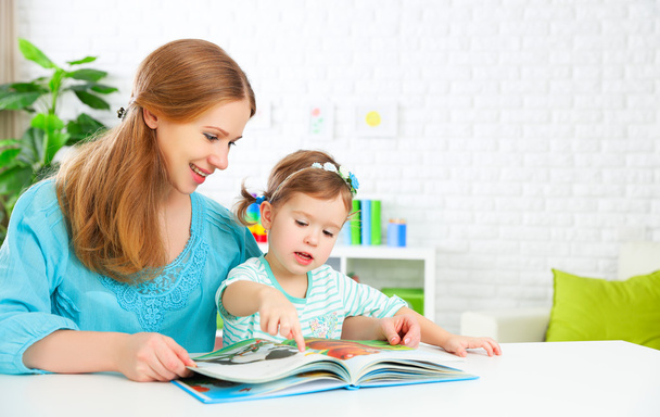 mother and child reading  book at home - Photo, Image