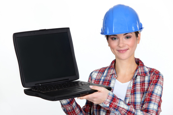 Female contractor holding laptop - 写真・画像