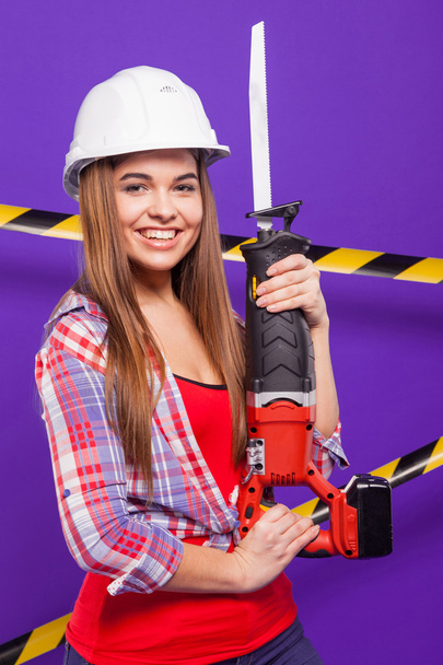 plus-size model on a blue background with the construction of th - Zdjęcie, obraz