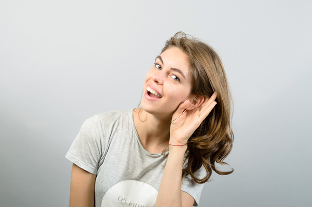 Young woman trying to hearing something - Photo, Image