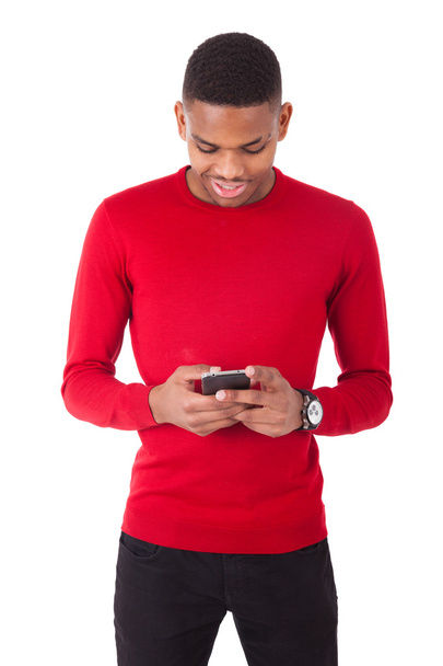 African American young man sending a text message on her smartph - Fotografie, Obrázek
