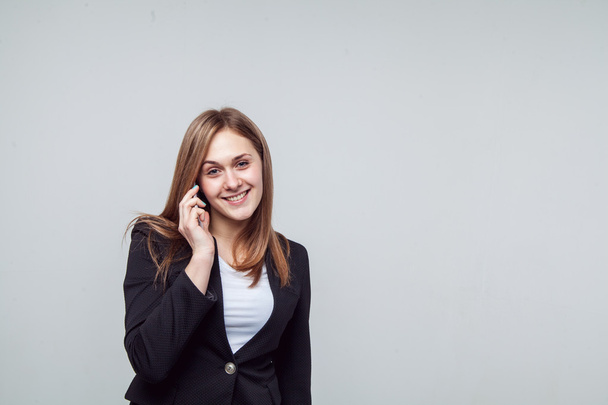 Beautiful smiling business woman talking on the phone - 写真・画像