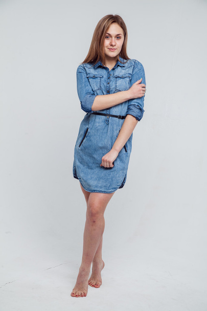 Portrait of a girl in a blue denim dress - isolated on white background - Foto, imagen