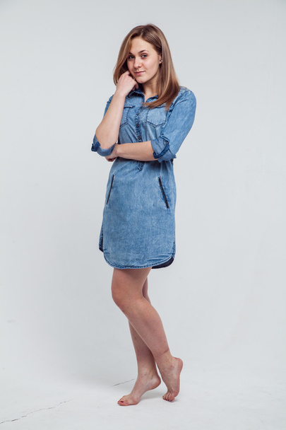Portrait of a girl in a blue denim dress - isolated on white background - Foto, Imagem