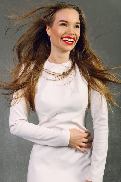 Smiling woman wears white dress - Фото, изображение