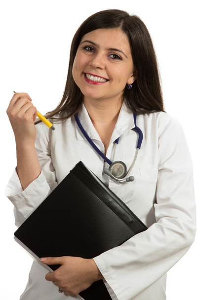 Young friendly beautiful female doctor holding folder and smiling - Foto, afbeelding